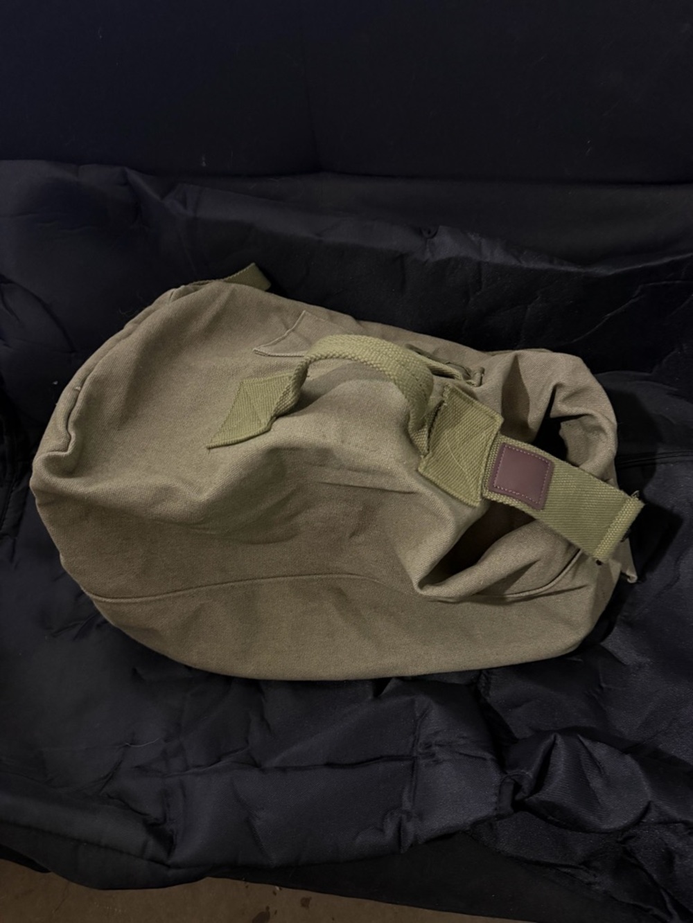 Tan canvas military rucksack can be carried as a backpack or a dufffle bag